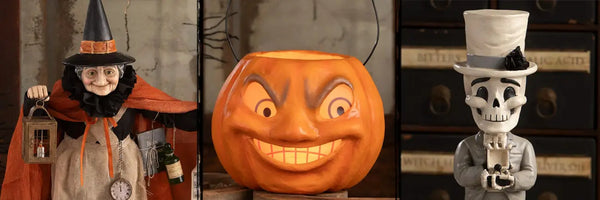 A Witch wearing an orange cape, a jack-o-lantern, and white skeleton figural decor by Bethany Lowe