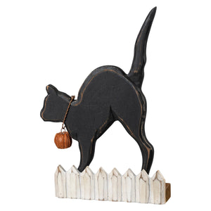 Black wooden cat chunky sitter with pumpkin on collar standing on white picket fence base fence chunky sitter