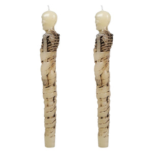 Two off-white 10 inch skeleton taper candles with detailed ribcage and bandaged design for spooky pumpkin taper candles