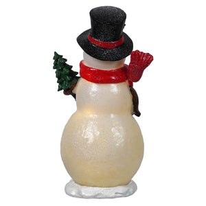 A glittery white lighted merry snowman wearing a black top hat and red scarf holding a small green christmas tree