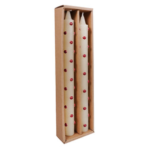 Cream-colored red dot taper candles with red spherical embellishments in a cardboard box candle set by creative co-op