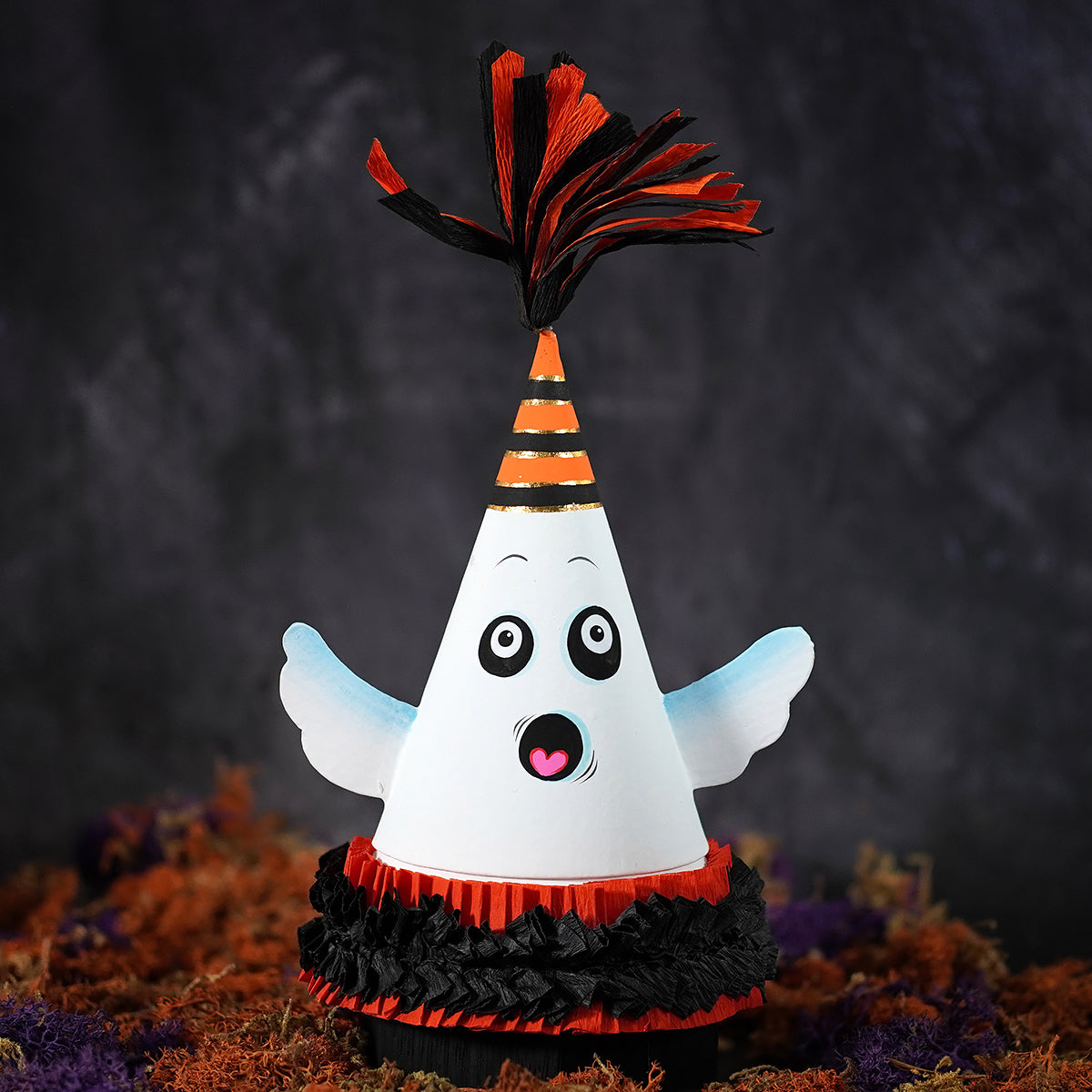 10 inch spooky ghost party favor cone box with white paper ghost, striped hat, blue wings, and fringed base