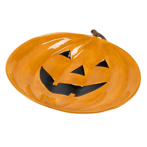 Vibrant orange ceramic jack o lantern platter with pumpkin design and black cutout eyes and mouth with brown stem