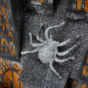 A glittery silver spider decoration with a sparkly textured surface for the lighted haunted house sitter dead & breakfast