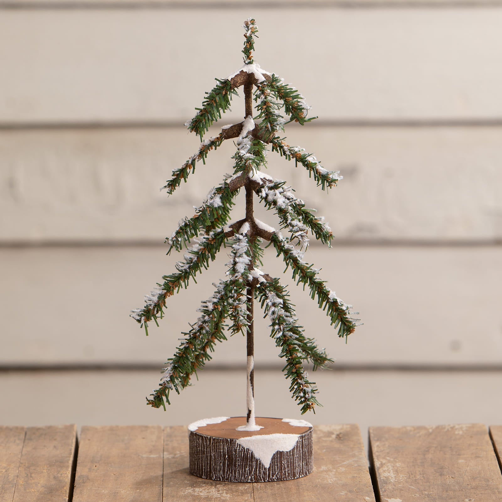 11 inch sparse bottle brush tree with faux snow dusted evergreen branches and rustic wooden base for vintage villages