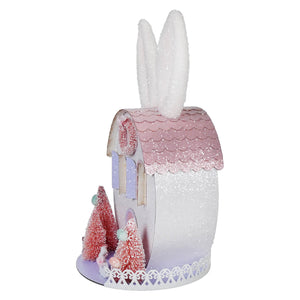 A glittery pink and white bunny ears house with lighted led pink and purple easter bunny design and frosted pine trees