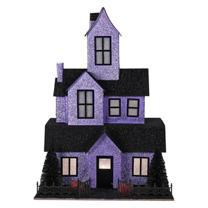 A 12.75 lighted purple haunted house with black roofs and fence perfect for halloween lights and decor or halloween village houses and accessories