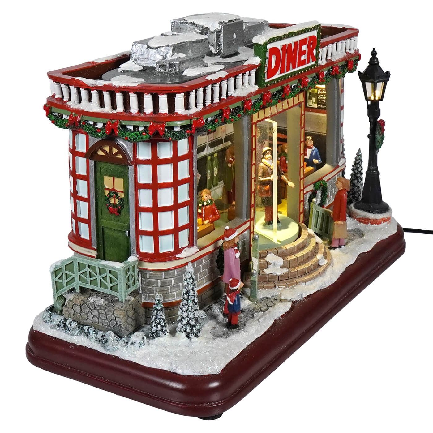 12 animated winter scene diner with red and white colors, snow roof, wreath, lights, figurines, and classic christmas tunes