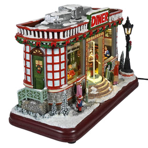 12 animated winter scene diner with red and white colors, snow roof, wreath, lights, figurines, and classic christmas tunes
