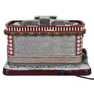 12 animated winter scene diner with red and gray brick style, snow dusted roof, garland, lights, and classic christmas tunes