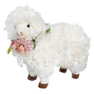 A 12 inch fluffy white standing sheep with soft textured wool and a flower wreath spreading holiday cheer