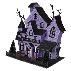 12 inch lighted purple haunted house with glitter, black roofs, halloween lights and decor pumpkins and bare trees