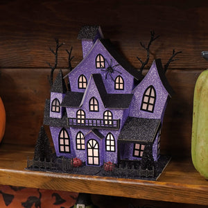 12 inch lighted purple haunted house with black roof and glittery halloween lights and decor details