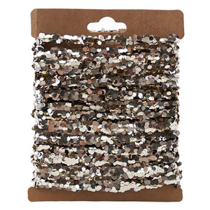 A 120 inch champagne finish string glitter holiday garland in silver rose gold and bronze on a kraft card display
