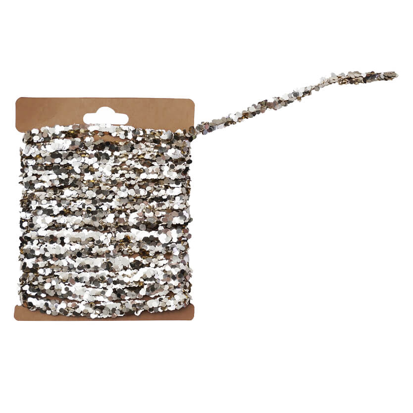 A shimmering silver sequin trim with reflective metallic flakes on kraft card perfect for holiday garlands and christmas garlands