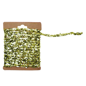 A spool of shimmering olive green and silver string glitter garland with a gold finish on a kraft card display