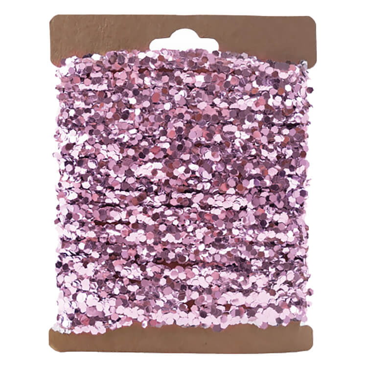 A spool of pink string garland with shimmering hexagonal sequin texture perfect for holiday garlands and christmas garlands