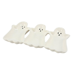 White ceramic ghost shaped tray with black dot eyes perfect for serving snacks at vintage halloween paper parties