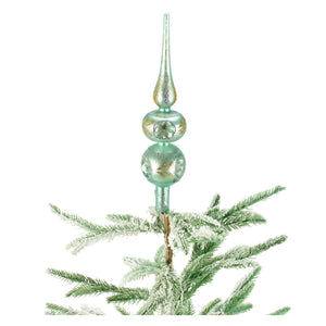 A delicate 13 inch glass tree topper in mint green with gold glitter and floral patterns for blue glass tree decor