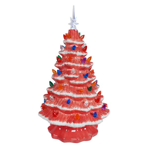 A large lighted pink ceramic christmas tree with colorful bulbs and a clear star topper from degrees design