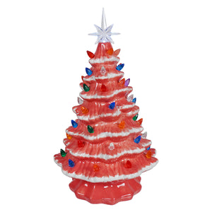 A large lighted pink ceramic christmas tree with vibrant coral color and multicolored lights by degrees design