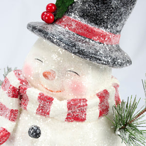 A cheerful jolly snowman figurine wearing a glittery black top hat and red white scarf perfect for christmas snowman decor