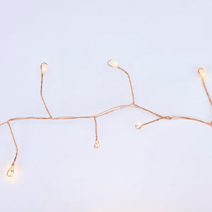 Copper string lights with delicate copper-colored candy cane wire and warm-toned led holiday lights in branching pattern