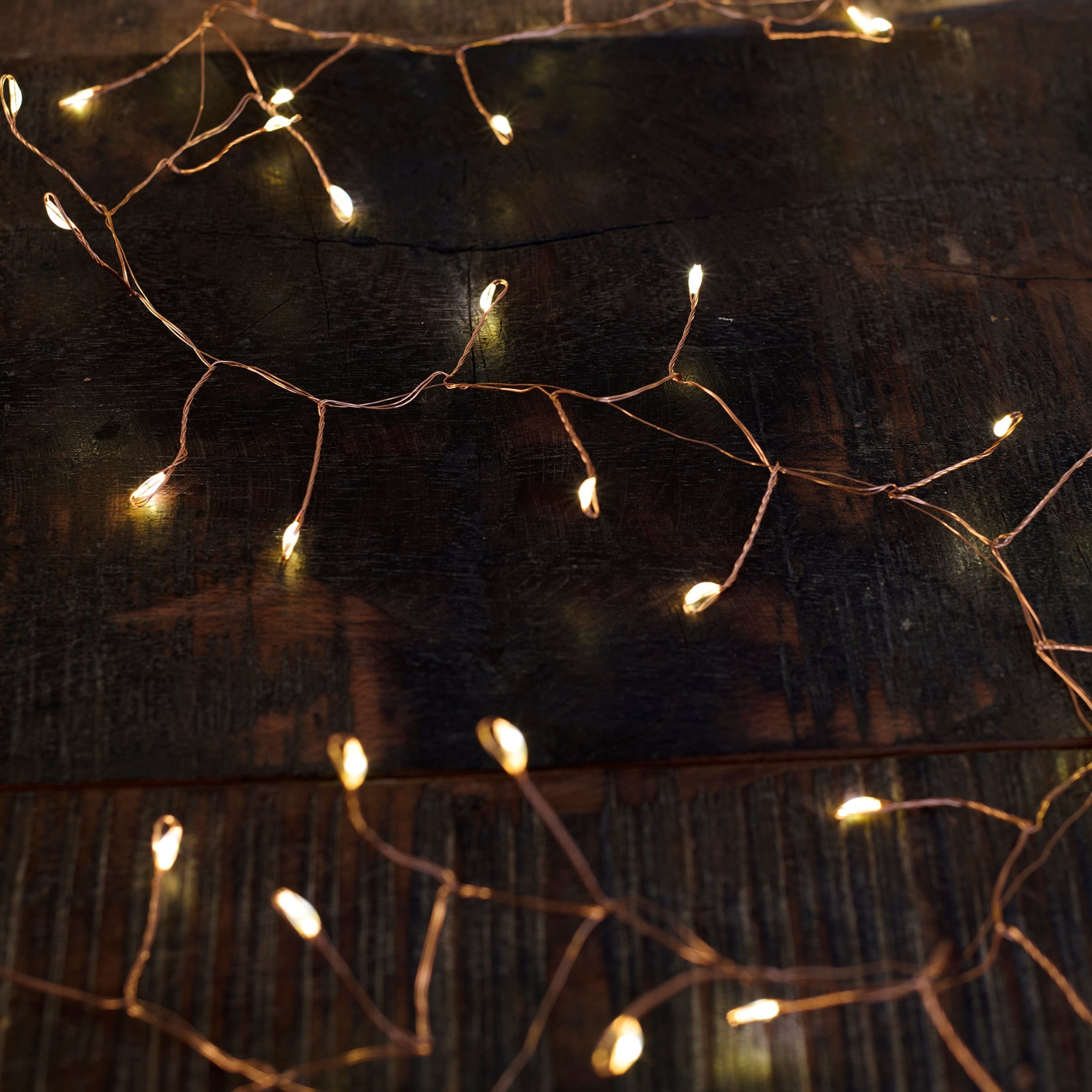 Delicate copper string lights with warm glowing bulbs in a branching pattern perfect for candy cane wire holiday lights decor