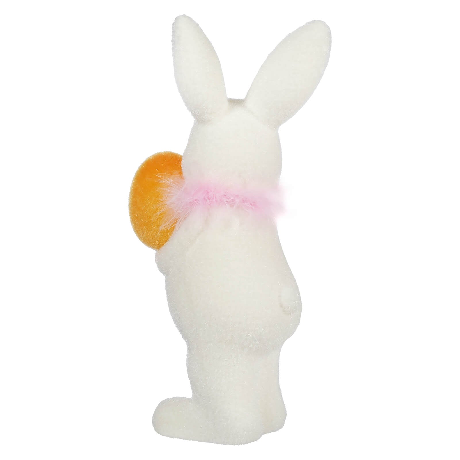 White bunny figurine wearing a pink bow and holding an orange egg.