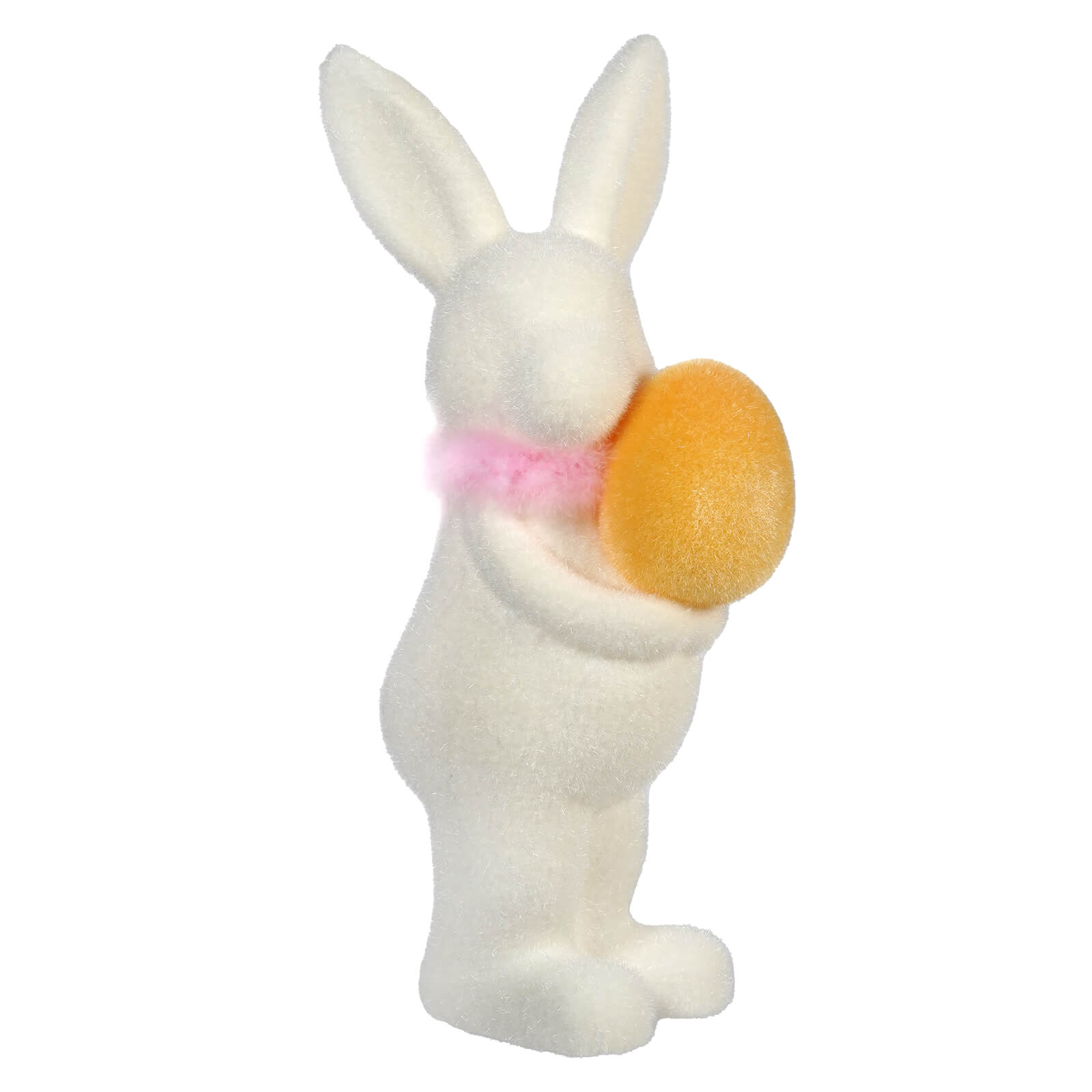 White ceramic bunny figurine holding an orange egg and wearing a pink bow.