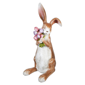 Serene brown bunny figurine clutching spring floral bouquet in brown and white holding flowers 16 inch tall