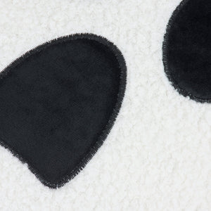 Black plush panda ear patch with fuzzy texture and frayed edge on ghost shaped pillow