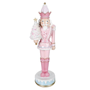 Pink and white pastel pink resin dessert toy nutcracker holding a christmas tree standing 18 inches tall