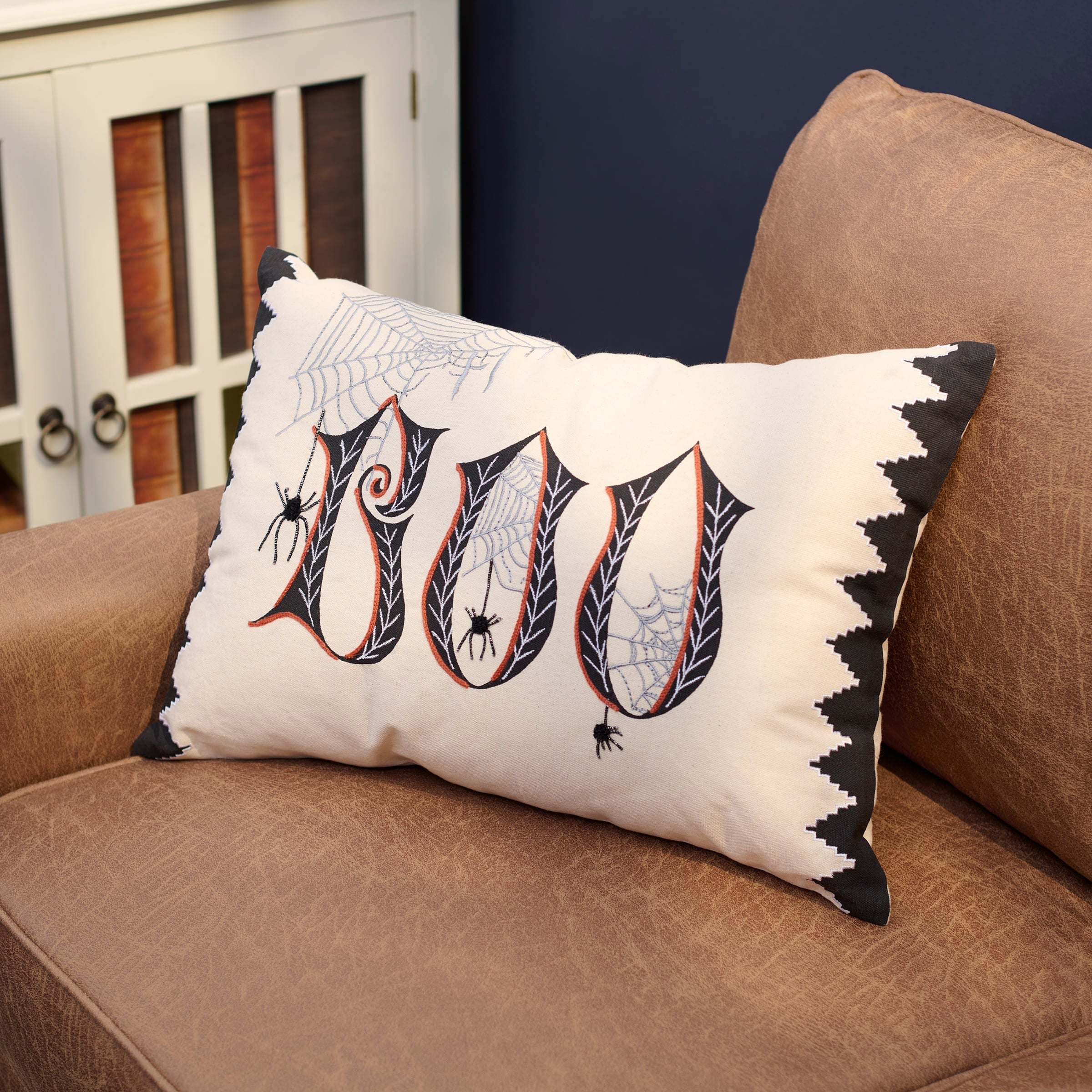 White rectangular boo spider pillow with embroidered black orange letters and spiderweb patterns halloween pillows