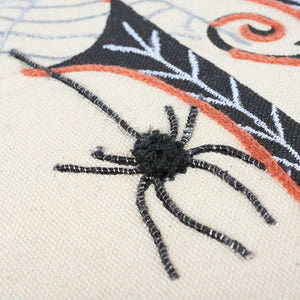 Black embroidered spider with textured body and striped legs on cream fabric for boo pumpkin pillow halloween pillows