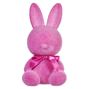 Pink plush bunny with a satin bow around its neck.