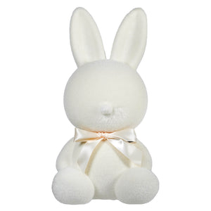 White plush bunny with a cream-colored bow around its neck.