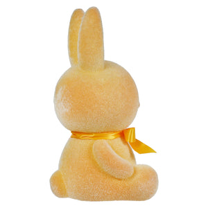 Yellow plush bunny with an orange ribbon around its neck.