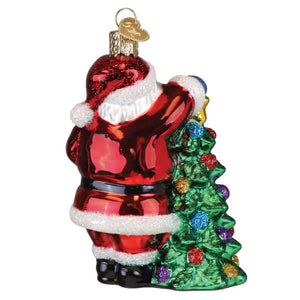 2025 santa with tree ornament world christmas glass red and white glass santa holding green christmas tree with glitter details