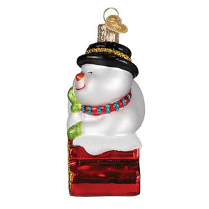 A charming white glass snowman ornament with black top hat and colorful scarf from world christmas family owned