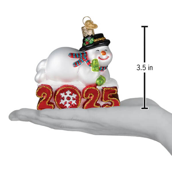 White glass snowman ornament with black hat and striped scarf sitting on red 2025 numbers by family owned world christmas