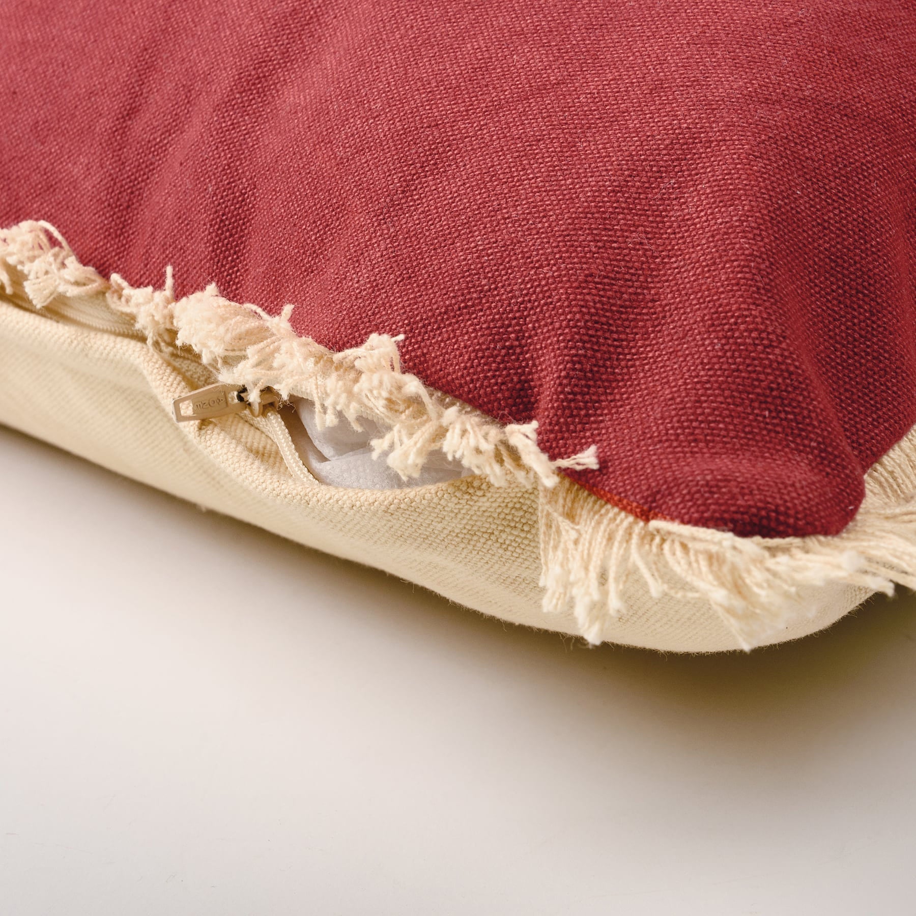 Red naughty nice pillow with frayed cream fabric edges and zipper perfect for holiday pillows by dan dipaolo
