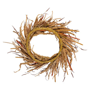 A rustic fall harvest wreath made of dried golden and brown grasses with orange seed sprays in a circular design