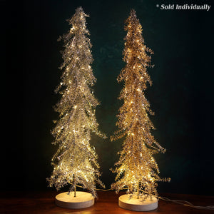 Two led lighted silver tinsel metal christmas trees with wood bases in silver and warm gold for holiday decor