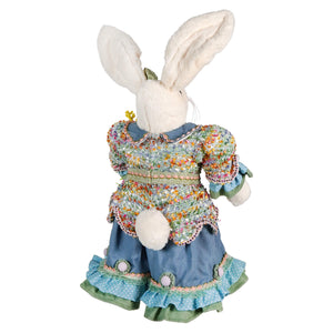 A plush 24 inch raz imports vintage easter bunny figurine in a blue green floral ruffled dress holding flowers