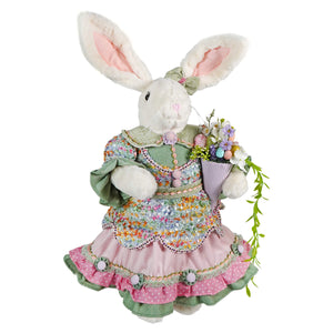 A plush 24 inch vintage easter bunny figural decor dressed in pink ruffled floral skirt holding a bouquet of flowers