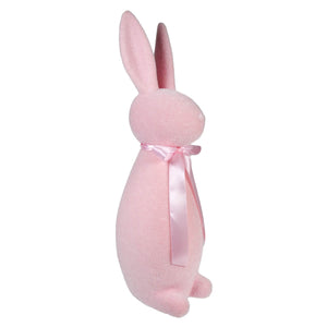 Pink plush bunny with a satin bow around its neck.