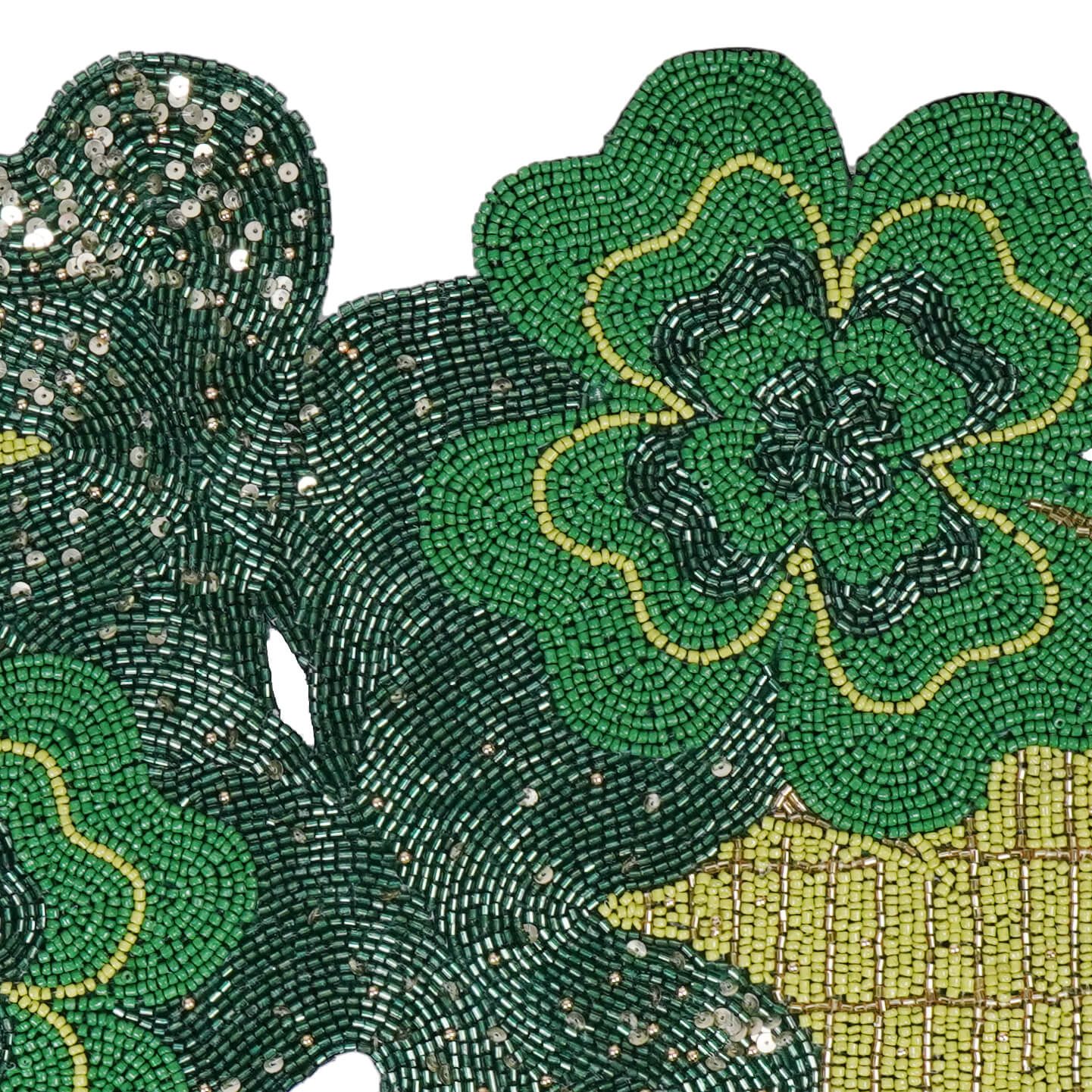 Beaded green shamrock with gold accents made from intricate beadwork.