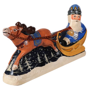 Hand-painted vaillancourt folk art blue coat santa in sleigh pulled by orange reindeer in snowy pine scene