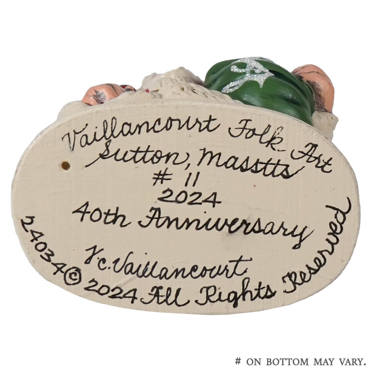 This vaillancourt folk art american santa figurine features ceramic with green and pink details in red coat